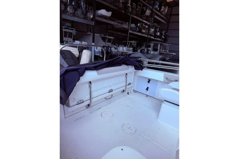 Slide: The Image of 2020 Robalo R227 Dual Console boat interior in storage facility. - 6