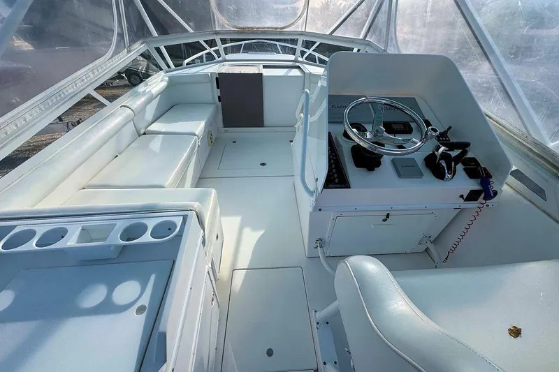 Slide: The Image of 2005 Contender 35 Express Side Console boat interior with steering wheel and seating. - 10