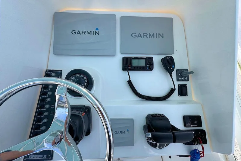 Slide: The Image of Console of 2005 Contender 35 Express with Garmin electronics and steering wheel. - 11