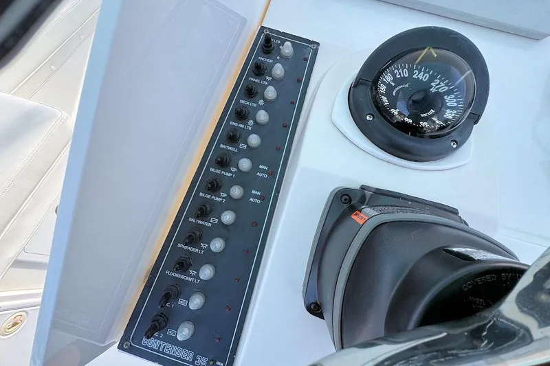 Slide: The Image of Control panel and compass of 2005 Contender 35 Express Side Console boat. - 12