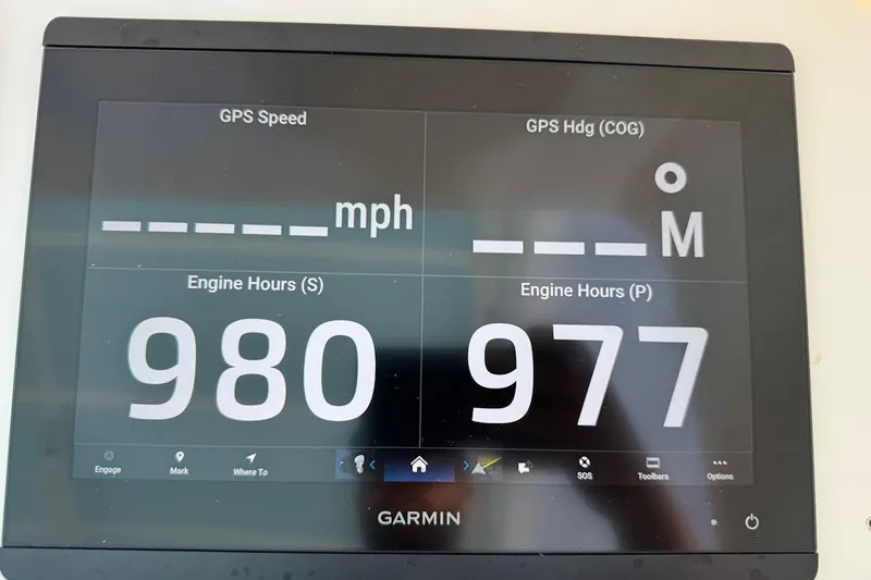 Slide: The Image of Garmin display showing engine hours for 2005 Contender 35 Express Side Console. - 13