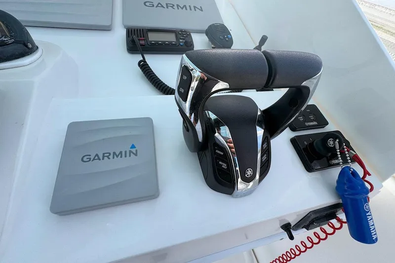 Slide: The Image of Control panel of 2005 Contender 35 Express Side Console with Garmin and Yamaha equipment. - 14