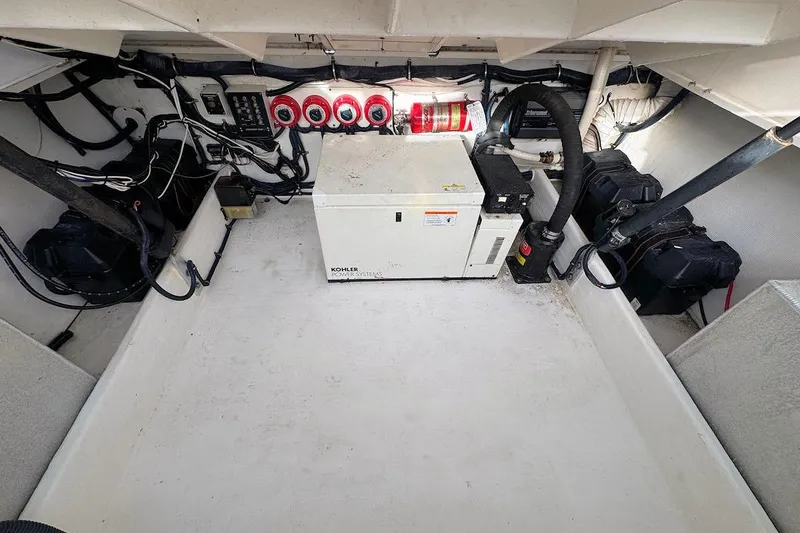 Slide: The Image of Engine compartment of 2005 Contender 35 Express Side Console with Kohler power system. - 15