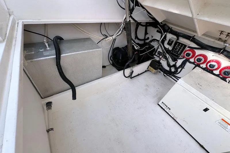 Slide: The Image of 2005 Contender 35 Express Side Console engine compartment with wiring and equipment. - 16