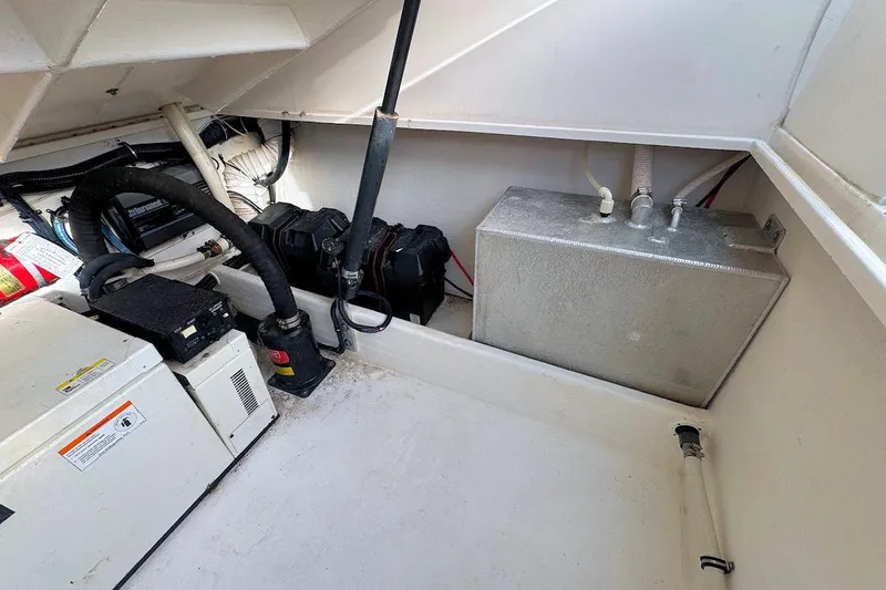 Slide: The Image of 2005 Contender 35 Express Side Console engine compartment with equipment and wiring. - 17