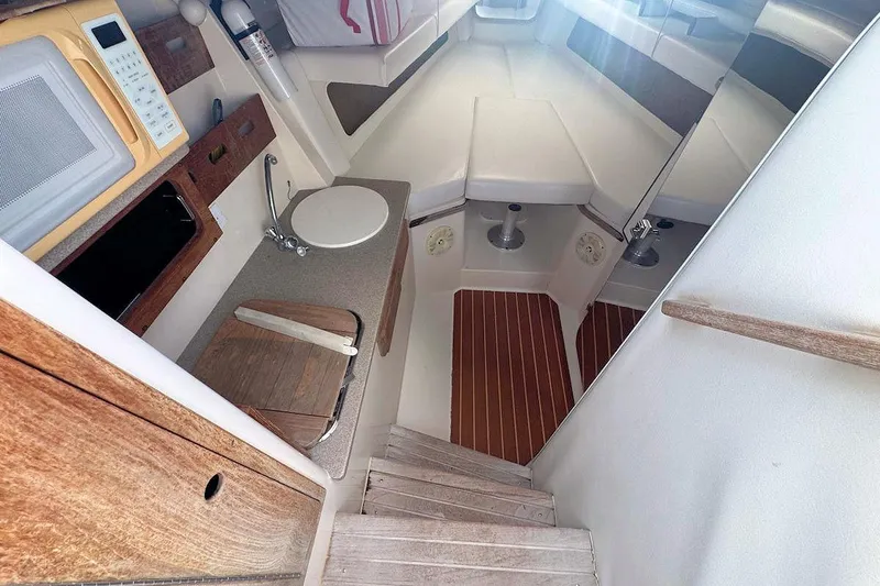 Slide: The Image of 2005 Contender 35 Express Side Console interior with kitchenette and seating area. - 20