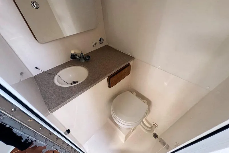 Slide: The Image of 2005 Contender 35 Express Side Console boat bathroom with sink and toilet. - 22