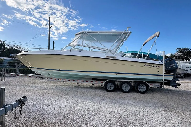Slide: The Image of 2005 Contender 35 Express Side Console boat on trailer under blue sky. - 4