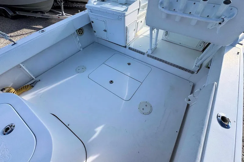 Slide: The Image of 2005 Contender 35 Express Side Console boat deck with storage compartments. - 8