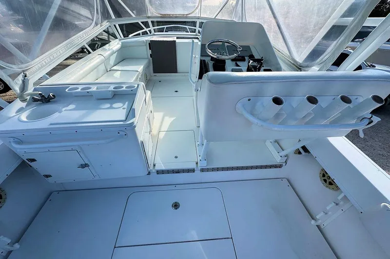 Slide: The Image of 2005 Contender 35 Express Side Console boat interior with seating and helm station. - 9