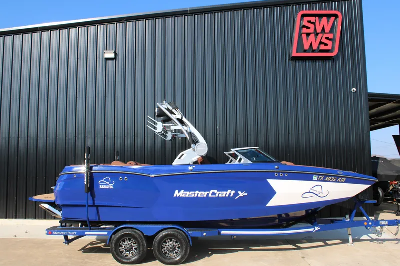 The Image of 2021 MasterCraft XStar boat in blue, parked outside SWWS building. - 0