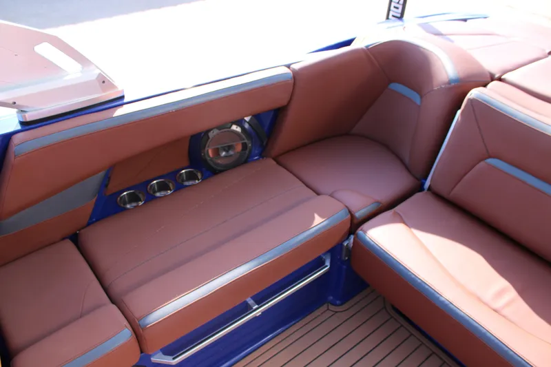 Slide: The Image of Luxurious interior of 2021 MasterCraft XStar boat with brown leather seating and cup holders. - 10