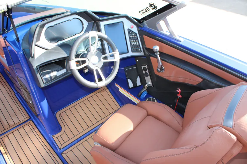 Slide: The Image of 2021 MasterCraft XStar boat interior with modern dashboard and leather seating. - 7