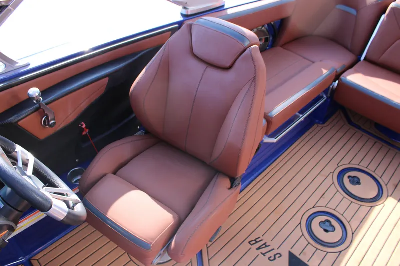 Slide: The Image of 2021 MasterCraft XStar interior with brown leather seats and stylish steering wheel. - 9
