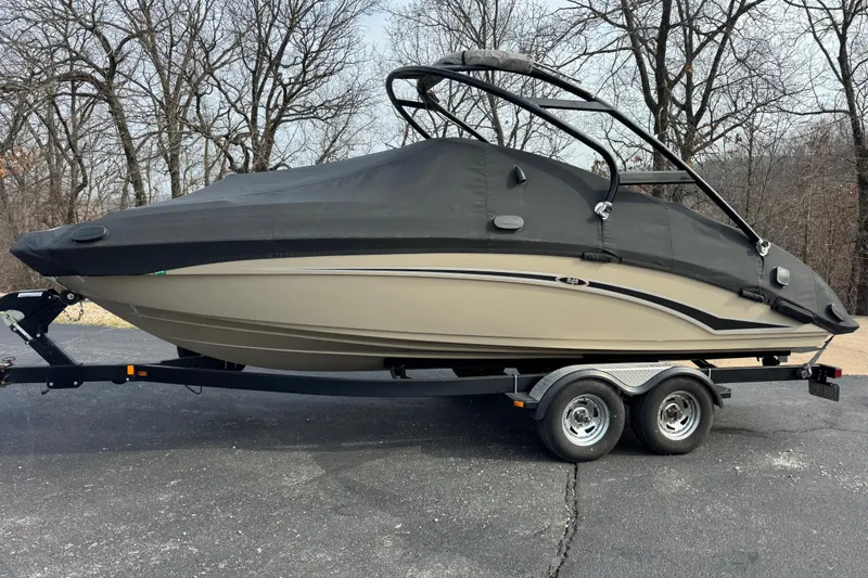 The Image of 2012 Yamaha Boats 242 Limited S covered on trailer, parked outdoors. - 0