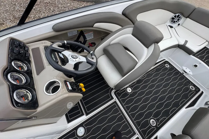 Slide: The Image of 2012 Yamaha Boats 242 Limited S cockpit with steering wheel and seating. - 10