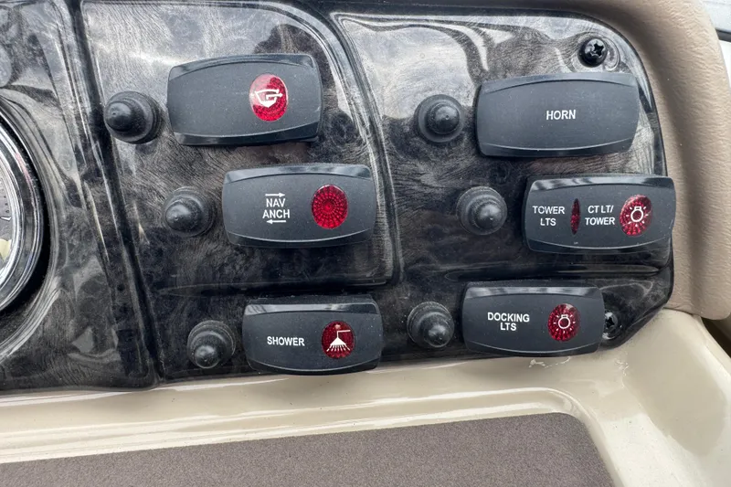 Slide: The Image of Control panel of a 2012 Yamaha Boats 242 Limited S with various switches. - 13