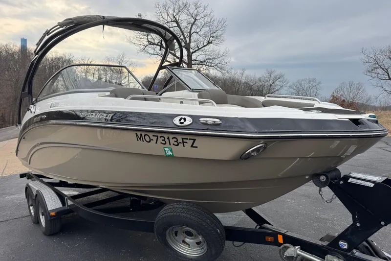 Slide: The Image of 2012 Yamaha Boats 242 Limited S on trailer, parked outdoors, showcasing sleek design. - 3