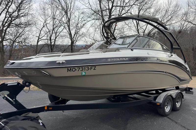 Slide: The Image of 2012 Yamaha Boats 242 Limited S on trailer, parked outdoors. - 4