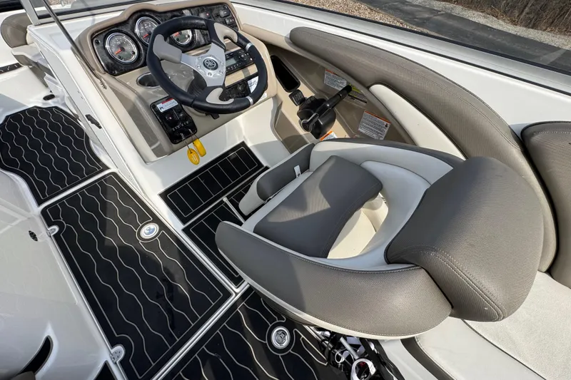 Slide: The Image of 2012 Yamaha Boats 242 Limited S cockpit with steering wheel and cushioned seating. - 9