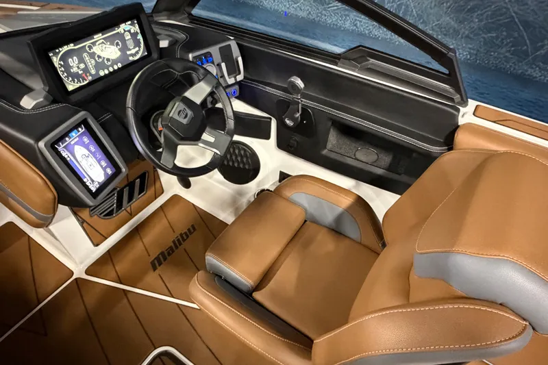 Slide: The Image of 2023 Malibu Wakesetter 23 LSV interior with modern dashboard and brown leather seating. - 10