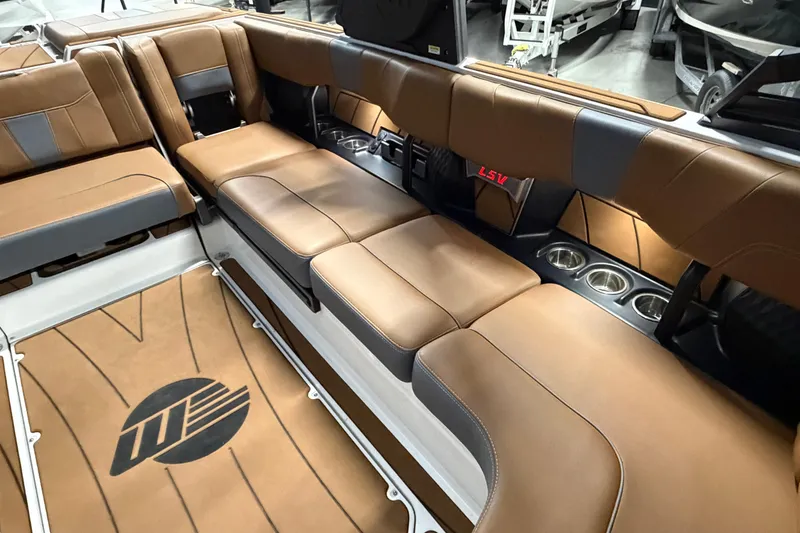 Slide: The Image of 2023 Malibu Wakesetter 23 LSV interior with brown leather seating and cup holders. - 13
