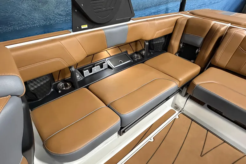Slide: The Image of 2023 Malibu Wakesetter 23 LSV interior with tan leather seating and cup holders. - 14