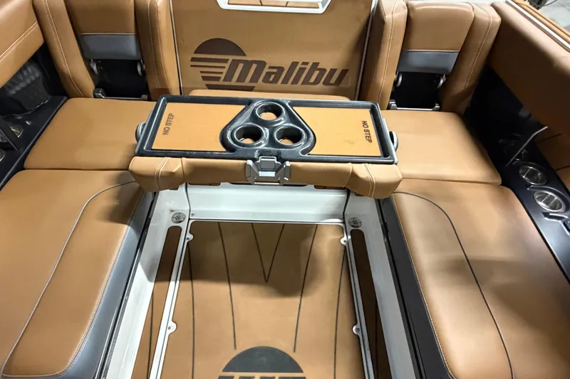 Slide: The Image of 2023 Malibu Wakesetter 23 LSV interior with tan leather seats and cup holders. - 16