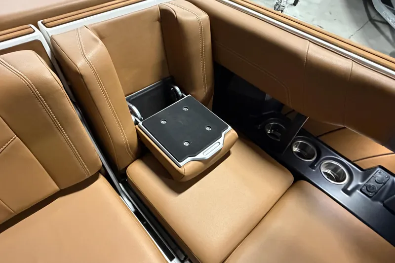 Slide: The Image of 2023 Malibu Wakesetter 23 LSV interior with tan leather seats and cup holders. - 17