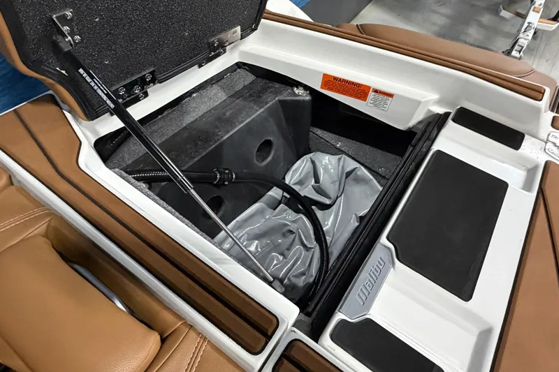 Slide: The Image of 2023 Malibu Wakesetter 23 LSV storage compartment with hydraulic lift and interior details. - 19