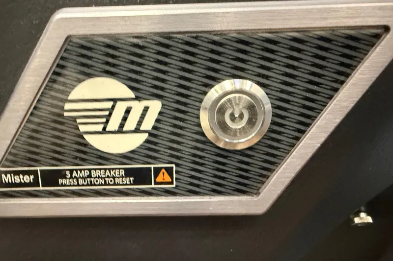 Slide: The Image of Close-up of 2023 Malibu Wakesetter 23 LSV 5 amp breaker reset button. - 25