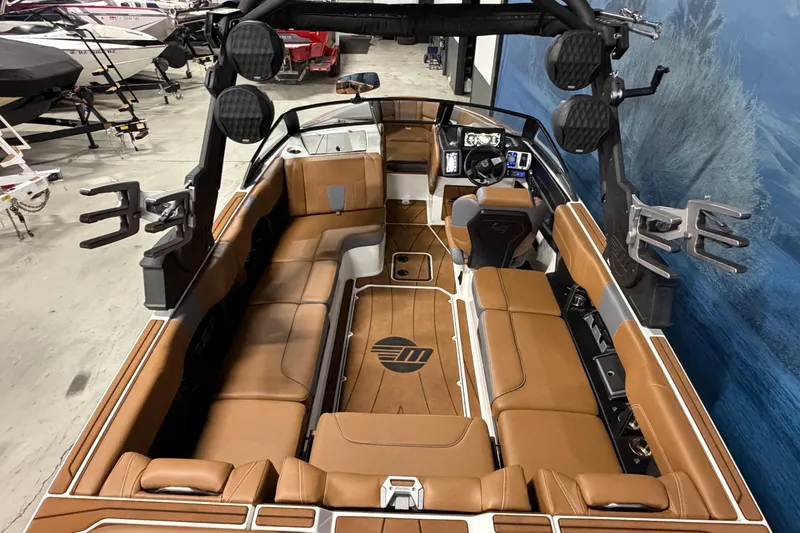 Slide: The Image of 2023 Malibu Wakesetter 23 LSV interior with brown leather seating and advanced dashboard. - 6