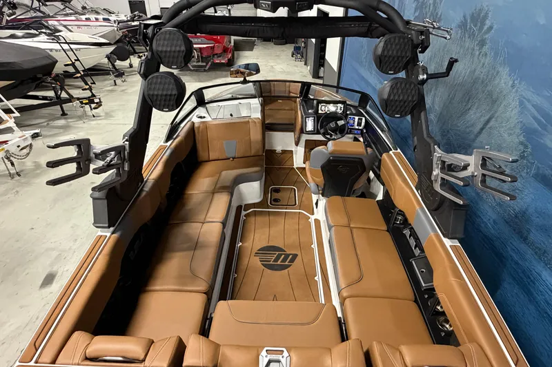 Slide: The Image of 2023 Malibu Wakesetter 23 LSV interior with brown seating and advanced dashboard. - 7