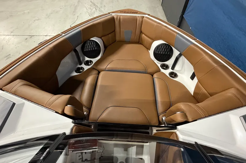Slide: The Image of 2023 Malibu Wakesetter 23 LSV interior with brown leather seating and cup holders. - 8