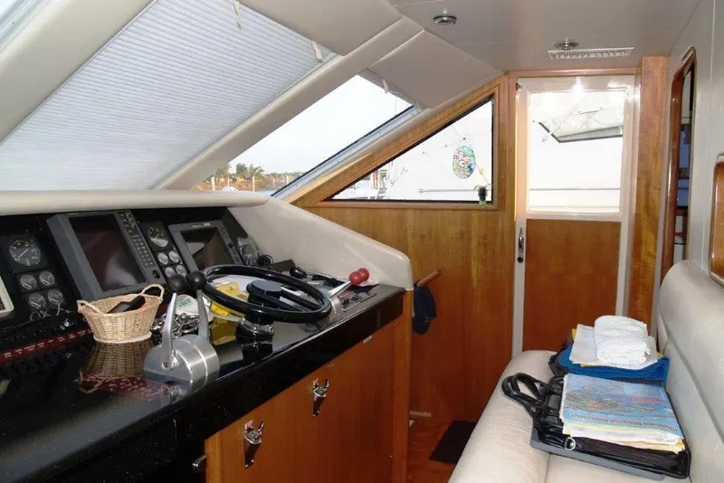 Slide: The Image of Interior of a 1991 Viking 65 Cockpit yacht with navigation controls and seating area. - 10