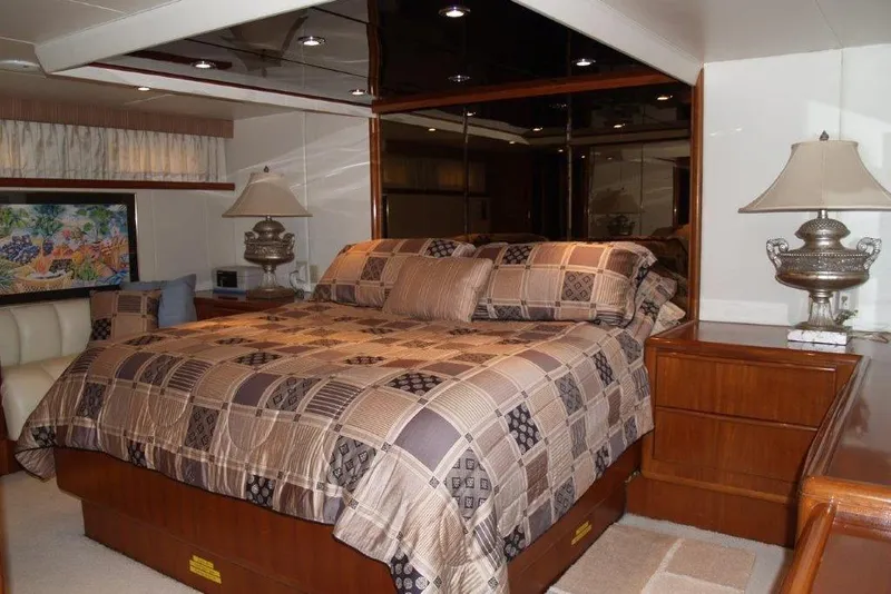 Slide: The Image of Luxurious bedroom interior of 1991 Viking 65 Cockpit yacht with elegant bedding and decor. - 14