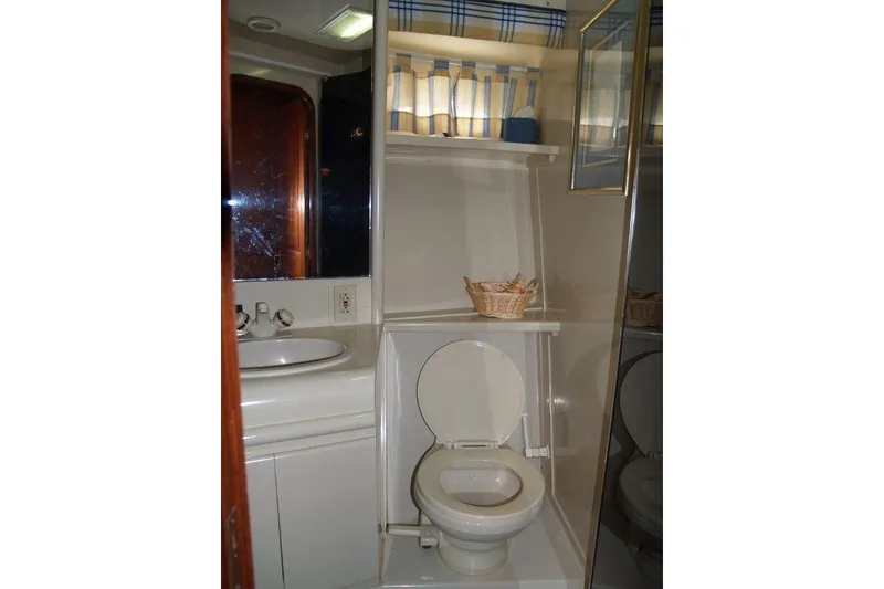 Slide: The Image of Bathroom interior of 1991 Viking 65 Cockpit yacht with sink and toilet. - 18