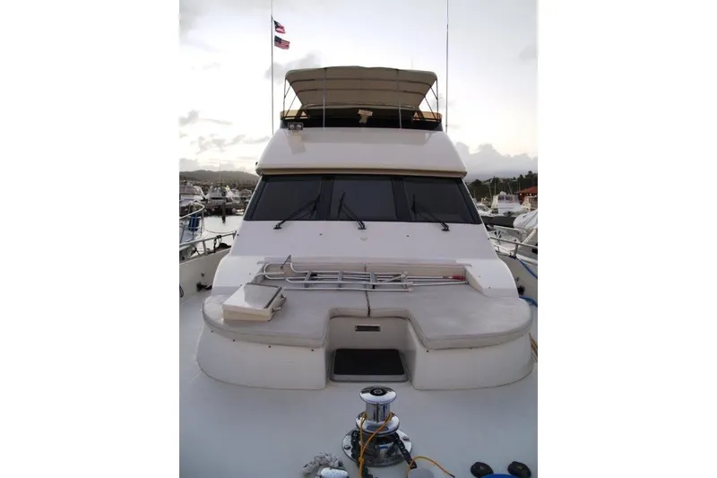 Slide: The Image of 1991 Viking 65 Cockpit yacht docked at marina, featuring spacious deck and flybridge. - 2