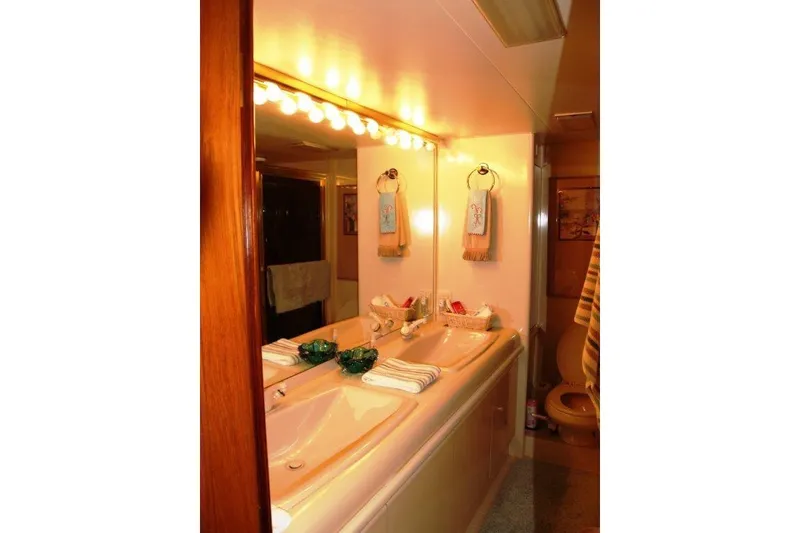 Slide: The Image of Luxurious bathroom in 1991 Viking 65 Cockpit yacht with double sinks and elegant lighting. - 20