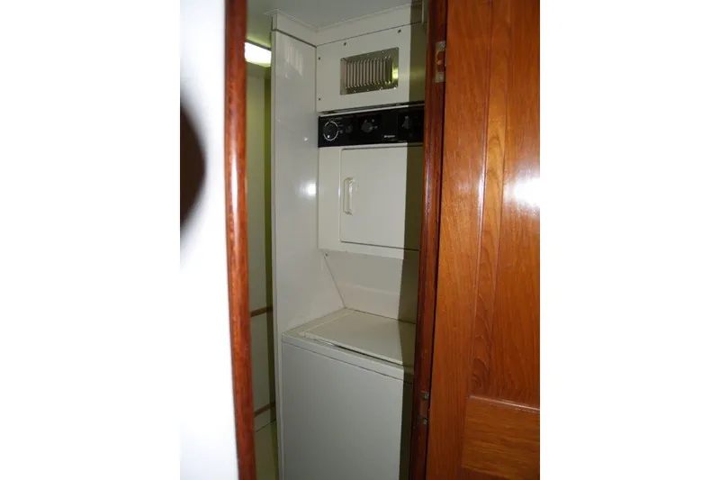 Slide: The Image of Laundry area inside 1991 Viking 65 Cockpit yacht with wooden door. - 23