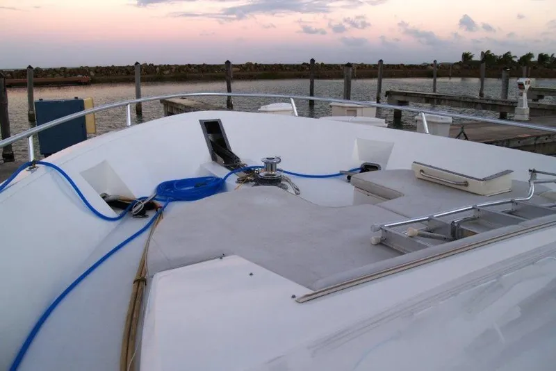 Slide: The Image of 1991 Viking 65 Cockpit yacht deck at sunset, docked with ropes and equipment. - 26