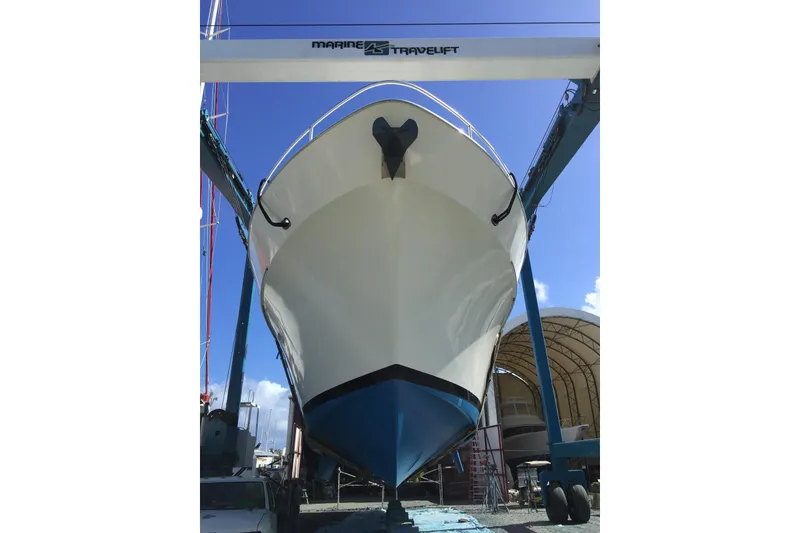 Slide: The Image of 1991 Viking 65 Cockpit yacht in dry dock, viewed from the front. - 3