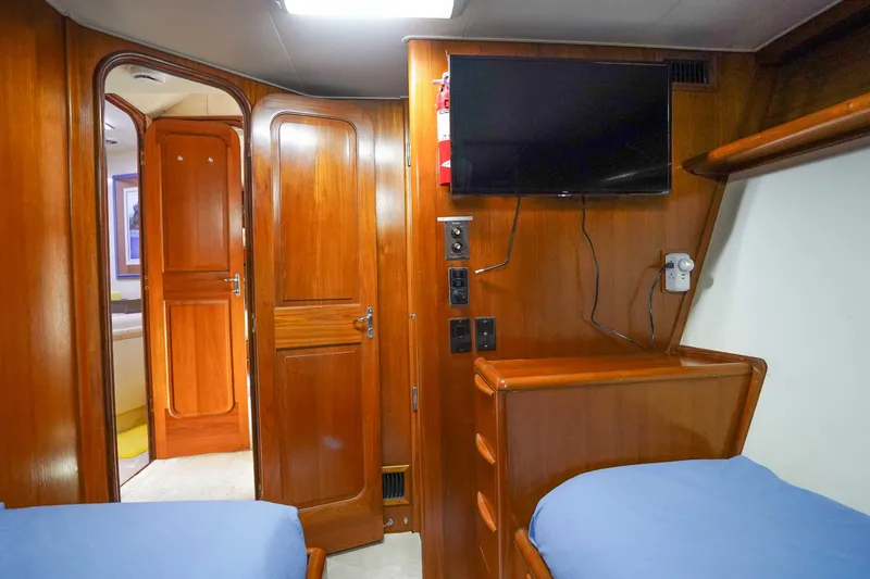 Slide: The Image of Interior of 1991 Viking 65 Cockpit yacht with wooden cabinetry and mounted TV. - 30