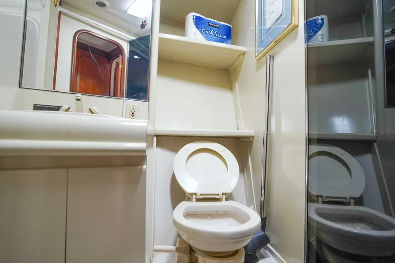 Slide: The Image of Bathroom interior of 1991 Viking 65 Cockpit yacht with toilet and mirror. - 34