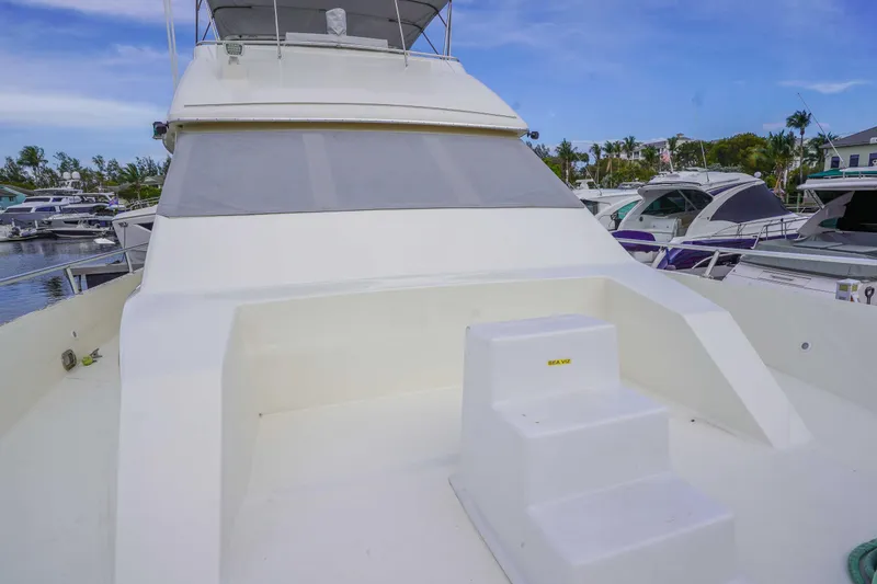 Slide: The Image of 1991 Viking 65 Cockpit yacht docked, featuring spacious deck and sleek design. - 35