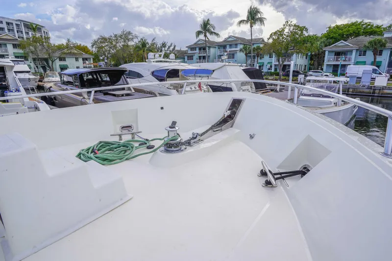 Slide: The Image of Bow view of a 1991 Viking 65 Cockpit yacht docked at a marina. - 37