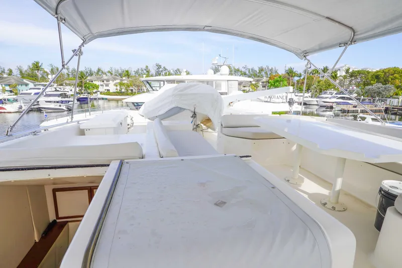 Slide: The Image of 1991 Viking 65 Cockpit yacht with spacious deck, docked in a marina setting. - 42