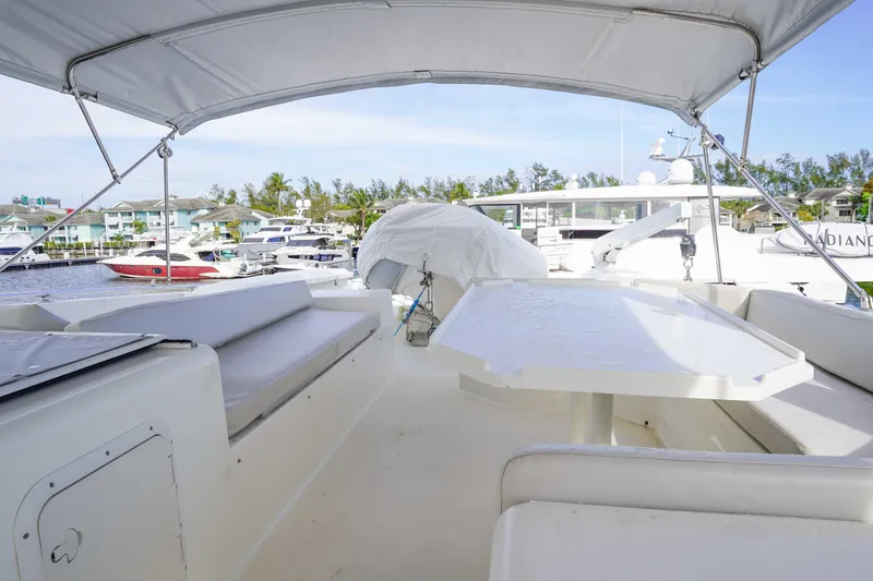 Slide: The Image of 1991 Viking 65 Cockpit yacht with spacious seating and table, docked at marina. - 43