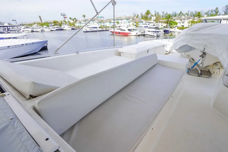 Slide: The Image of 1991 Viking 65 Cockpit yacht with spacious seating, docked in a marina with other boats. - 44