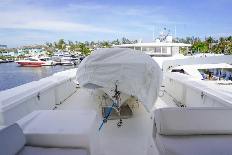 Slide: The Image of 1991 Viking 65 Cockpit yacht deck with covered equipment, docked in marina. - 45